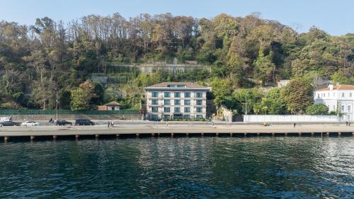 a large building on the shore of a body of water at MFB Tarabya Hotel in Istanbul