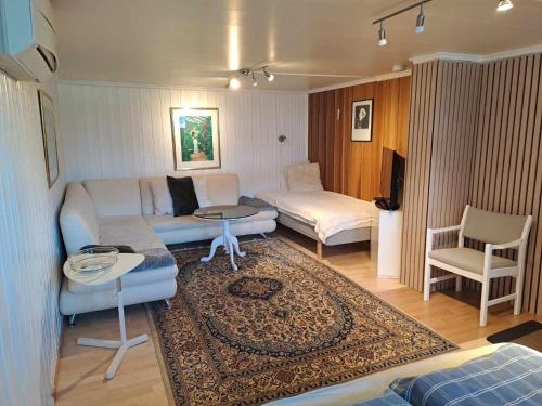 a living room with a couch and a table at Apartment Tryms vei 20a - Stor Leilighet in Kristiansand