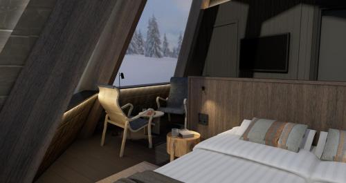 1 dormitorio con 1 cama, TV y silla en Nivunki Village, en Muonio
