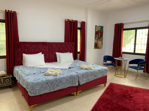 a bedroom with a large bed with two bows on it at Arabian Nights Nook in Muscat