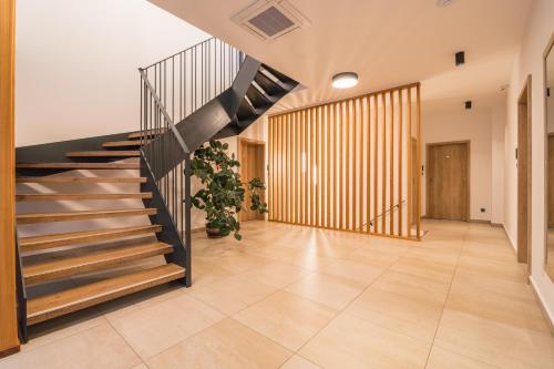 a hallway with a staircase in a house at Adalbert penzion Čejkovice in Čejkovice