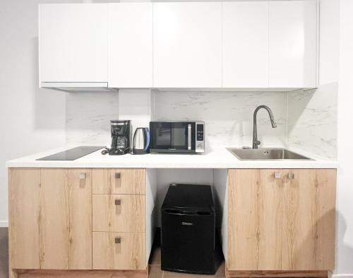 a kitchen with a sink and a microwave on a counter at ANhome K11 serviced apartments Plus in Athens