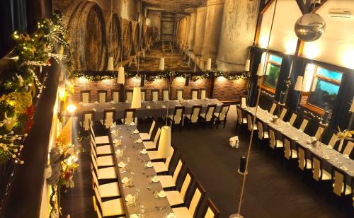 a room with long tables and chairs in a building at Pokoje gościnne Restauracja u Kusia in Mikołów