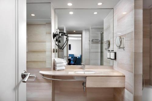 bagno con lavandino e specchio di Apartaments-Hotel Hispanos 7 Suiza a Barcellona