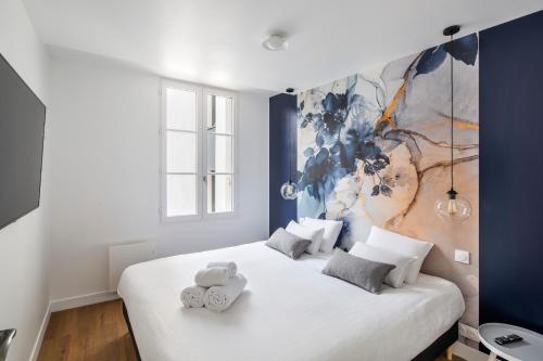 ein Schlafzimmer mit 2 Betten und einem Wandgemälde in der Unterkunft Appartements Le 31bis in Rennes