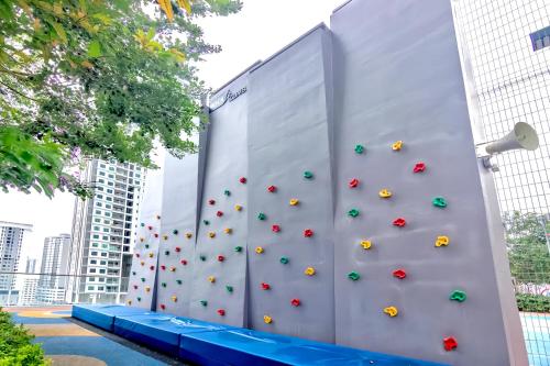 a wall with a climbing wall in a city at Urban Suites George Town in Jelutong