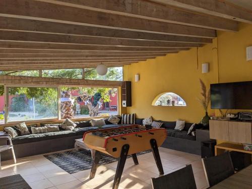 a living room with a ping pong table in the middle at Le Mas Del Cavalier in Baho