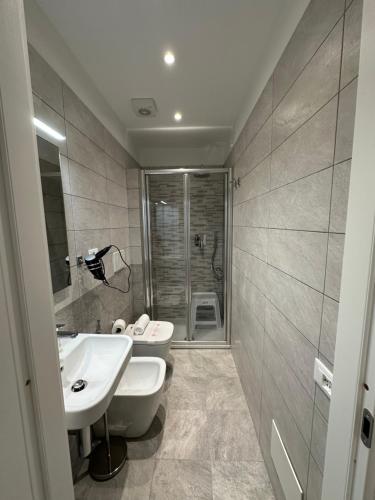 a bathroom with a sink and a toilet and a shower at Hotel La Bussola in Finale Ligure