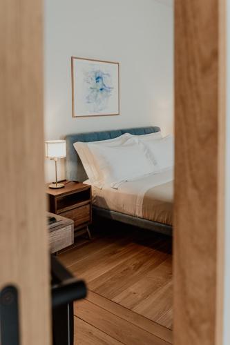 a bedroom with a bed and a table with a lamp at Club64 in Andria