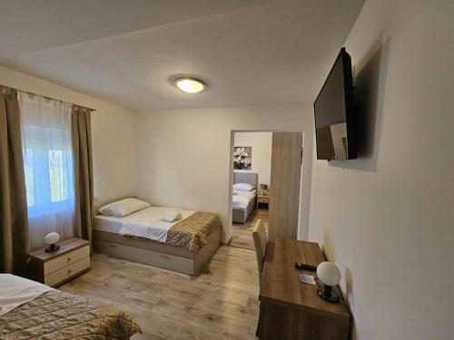 a hotel room with two beds and a mirror at B&B Villa Ellena in Međugorje