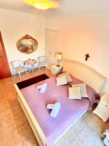 a bedroom with a large bed with two slippers on it at SV Apartment with sea view in Gouvia