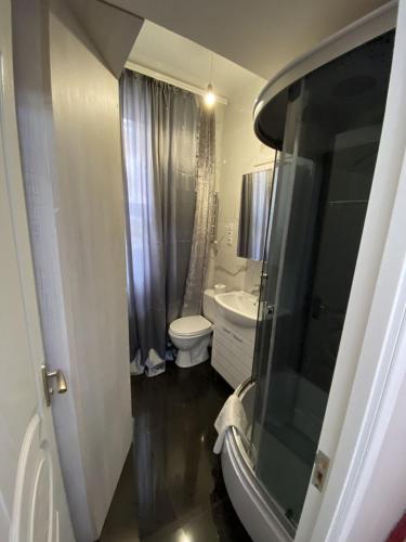 a bathroom with a toilet and a sink at UrbanView Studio in Chişinău