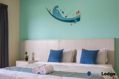 a bedroom with a large bed with towels on it at AnyLodge Waterfront Marina Island Pangkor in Lumut