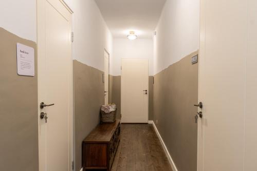 a hallway with two doors and a wooden floor at Art&Comfort Country in Kaunas
