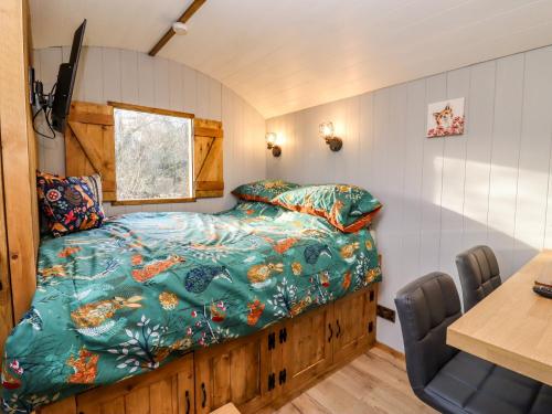 a bedroom with a bed in a small room at The Foxes Den Shepherds Hut in Bristol