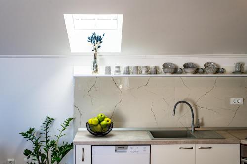 a kitchen with a bowl of fruit on a counter at Apartments Mariana in Dubrovnik