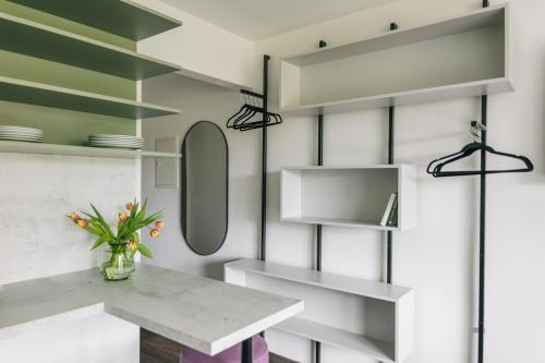 a kitchen with green and white shelves and a counter at Homaris Apartments Frankfurt in Frankfurt