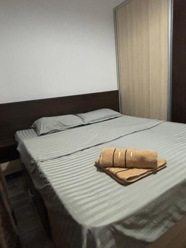 a bed with two towels sitting on top of it at Sweet Home Iasi Airport 2 in Iaşi