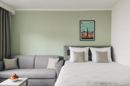 Ένα ή περισσότερα κρεβάτια σε δωμάτιο στο Homaris Apartments Frankfurt