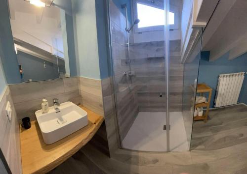a bathroom with a sink and a shower at La dolce vita al lago in Bogliaco