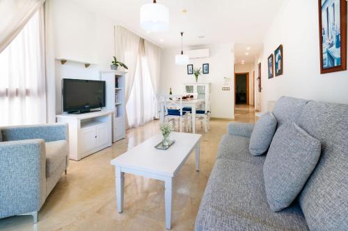 a living room with two couches and a table at Apartamentos Albir Confort - Avenida 1 dorm in Albir