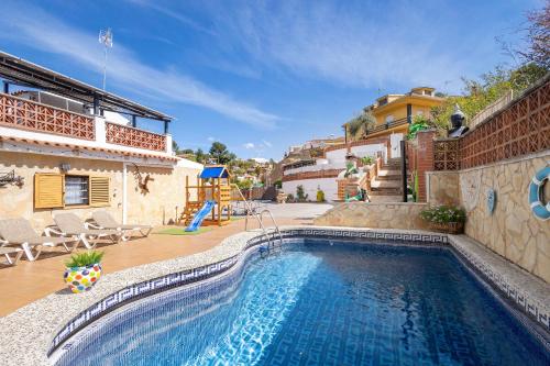 a swimming pool in front of a house at Cal Ramon con piscina in Rubí