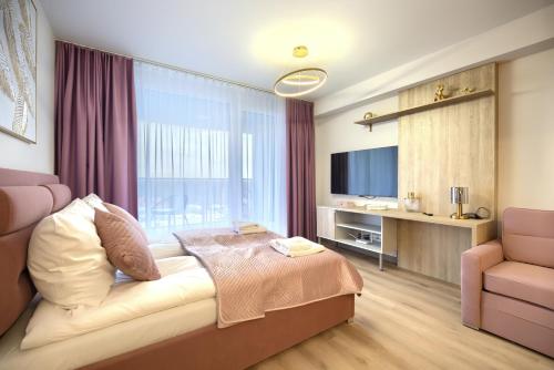 a bedroom with a bed and a large window at AboutArtApartments - Otyńska 4 in Wrocław