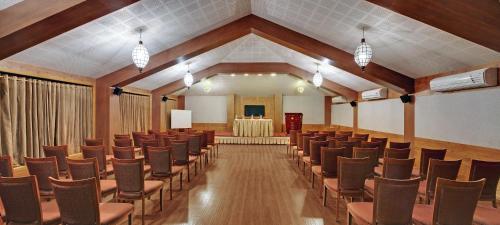 a conference room with chairs and a podium in the middle at The Fern Gir Forest Resort, Sasan Gir - A Fern Crown Collection Resort in Sasan Gir