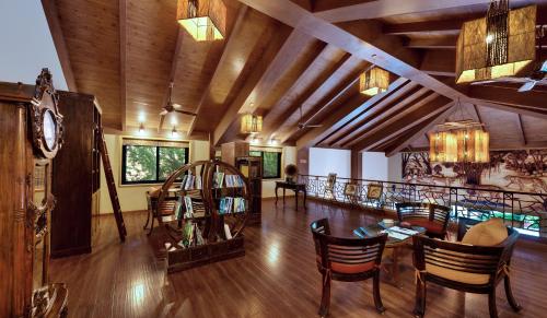 a large room with a table and chairs and a clock at The Fern Gir Forest Resort, Sasan Gir - A Fern Crown Collection Resort in Sasan Gir