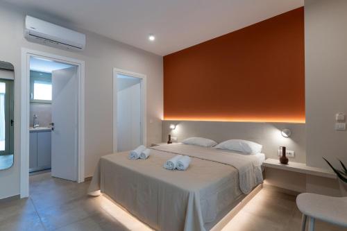 a bedroom with a bed with two towels on it at Lodge Apartments in Zakynthos