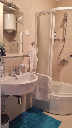 a bathroom with a sink and a shower and a toilet at Apartment Domino in Split