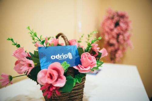 a basket filled with pink flowers on a table at Adria centar Koćuša in Ljubuški