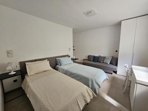 a hotel room with two beds and a couch at Villa Dune Luxury Roof Top Pool Wellness in Gallipoli