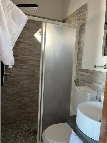 a bathroom with a toilet and a sink at Hotel Touring in Sottomarina