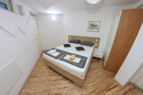 a bedroom with a bed and a wooden floor at Hotel Hayat in Sarajevo
