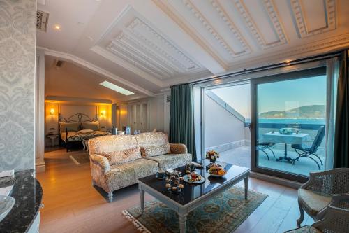 a living room with a couch and a table at MFB Tarabya Hotel in Istanbul