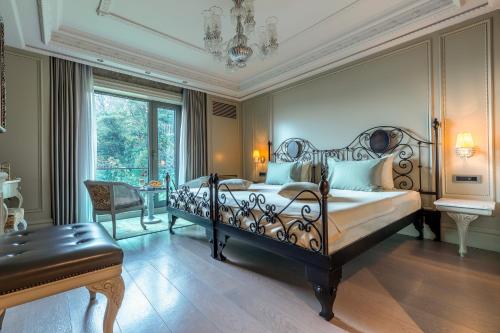 a bedroom with a bed and a table and a chair at MFB Tarabya Hotel in Istanbul