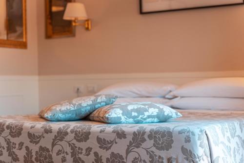 Uma cama ou camas num quarto em Hotel Modigliani