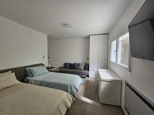a small bedroom with two beds and a couch at Villa Dune Luxury Roof Top Pool Wellness in Gallipoli