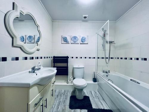 y baño con lavabo, aseo y bañera. en Lovely 4 bed (sleeps 8) apartment close to city en Mánchester
