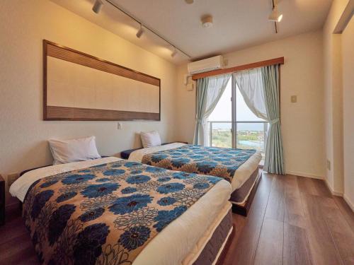 Ένα ή περισσότερα κρεβάτια σε δωμάτιο στο Yukurina Resort Okinawa