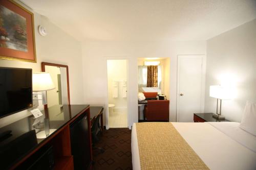 a hotel room with a bed and a television at Travelodge by Wyndham Burbank-Glendale in Burbank
