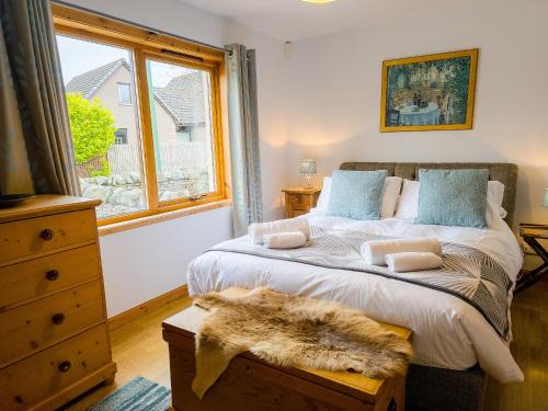 a bedroom with a large bed and a window at The Shambles in Aviemore