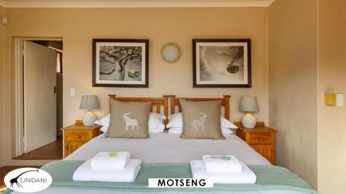 a bedroom with a bed with towels on it at Lindani Game and Lodges in Vaalwater