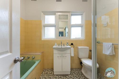 a bathroom with a sink and a toilet and a shower at Aircabin - Blakehurst - Spacious - 5 Beds House in Sydney