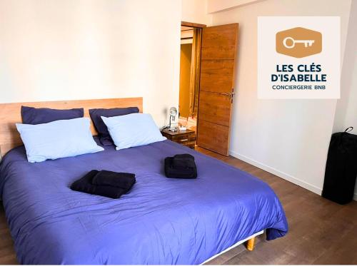 ein Schlafzimmer mit einem Bett mit zwei schwarzen Säcken darauf in der Unterkunft Appartement climatisé avec sa terrasse de 25 M2 in Limoges
