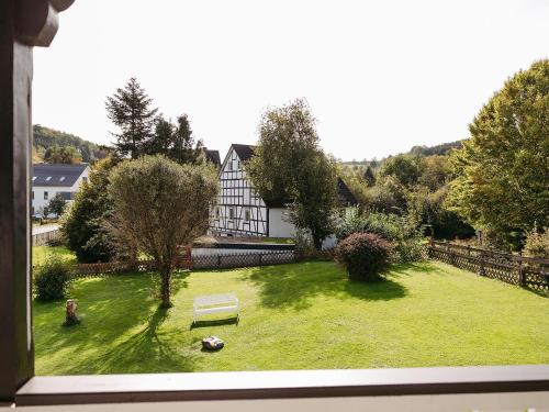 a view from a window of a yard with a house at Ferienwohnung Wennetal in Schmallenberg
