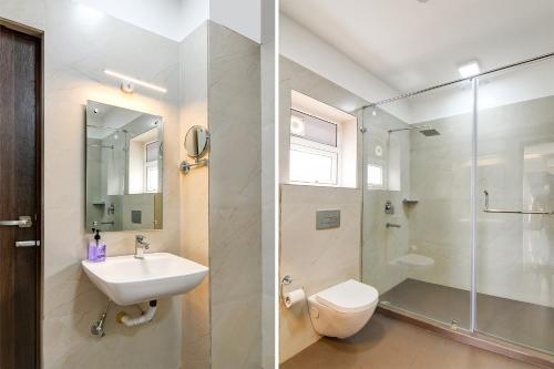 a bathroom with a sink and a toilet and a shower at AVS Prime in kolkata