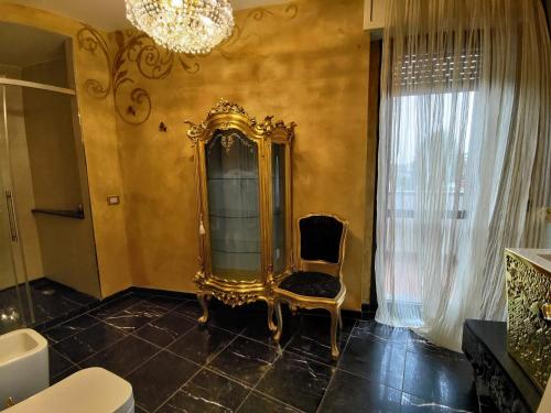 ein Badezimmer mit einem Stuhl und einem Spiegel in der Unterkunft Villa Eleganza Milano Bergamo Airport in Dalmine