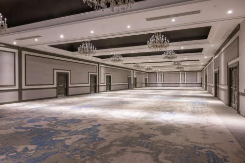 an empty ballroom with a large room with chandeliers at The Bethesdan Hotel, Tapestry Collection by Hilton in Bethesda